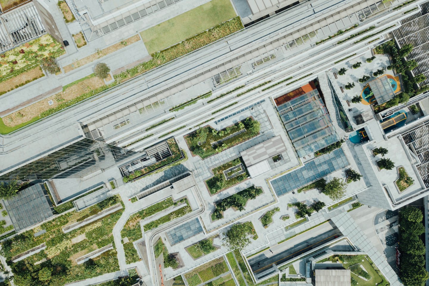 Modern urban complex with green spaces and concrete buildings.
